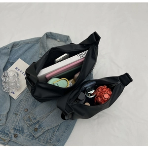 Detailed view of two black nylon crossbody bags showing large capacity storage space