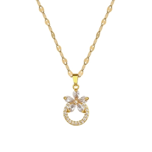 Elegant gold flower necklace with cubic zirconia pendant on a textured flat chain link