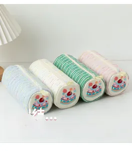 Detail of four colorful tweed pencil cases with cute strawberry cake embroidery icons