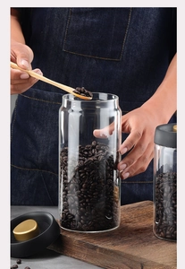 Vacuum sealed glass coffee canisters set with airtight lids and wooden spoon details