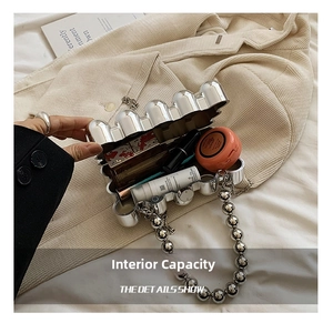 Detailed interior of a wavy silver acrylic clutch showing capacity for cosmetics
