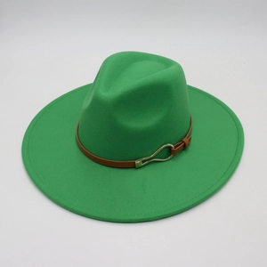 Detail of green fedora hat featuring a brown leather band and gold horseshoe buckle