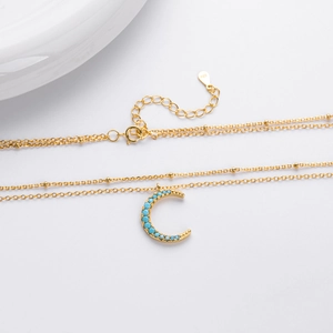 Detail of S925 sterling silver double layer necklace with turquoise moon pendant