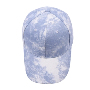 Detail of blue and white tie-dye cotton twill baseball cap with curved brim and stitching