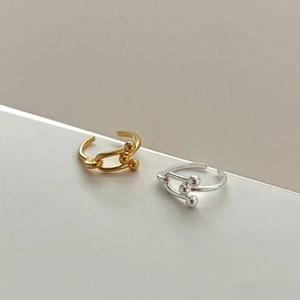 Detailed view of gold and silver S925 sterling silver chain link rings with spherical ends