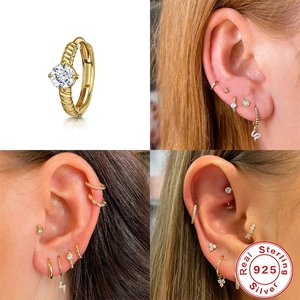 Detail view of S925 sterling silver gold huggie hoop with twisted texture and zircon