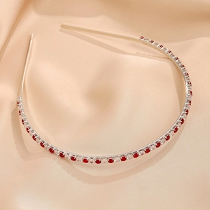 Detail of silver headband with alternating red and clear rectangular cubic zirconia gems