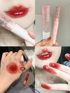 Glossy tomato red lip glaze texture with heart-shaped brush and swatches on lips and skin
