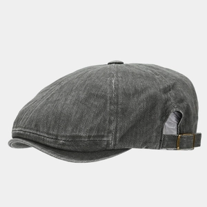 Detail of vintage washed cotton newsboy cap with adjustable metal buckle on back