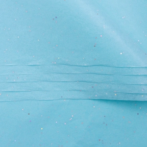 Macro detail of blue tissue paper with iridescent laser glitter for flower wrapping