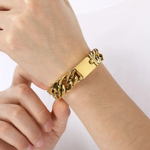Close-up of a men's 15mm gold titanium steel Cuban link bracelet on a male model's wrist