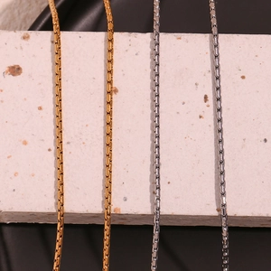 Detailed view of silver and gold stainless steel blade chains for body jewelry