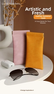 Minimalist leather eyewear pouches in pink and yellow with automatic metal closure