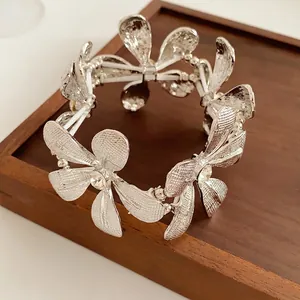 Eleganter silberner Blumen-Stretcharmband mit Strassstein und gebürsteter Metallstruktur