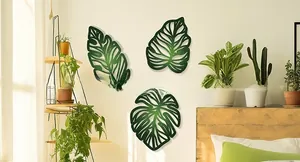 Three-piece set of wooden tropical palm leaf wall art in gradient green hollow design