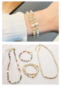 Detailed close-up of natural stone and pearl beaded necklace set with golden accents