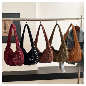 Close-up of suede shoulder bags in five colors with silver rivets and heart charms