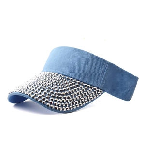 Detailed close-up of light blue sun visor hat featuring decorative silver rhinestones on brim