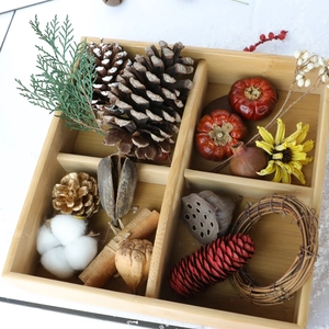Christmas DIY set with pine cones, dried flowers and cinnamon in a wooden box