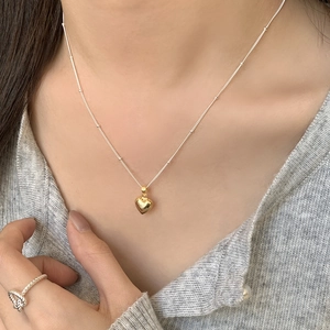 Minimalist silver bead chain necklace with gold heart pendant and silver twisted ring