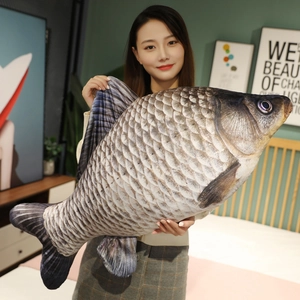 Close-up of oversized realistic fish plush pillow held by a person in a cozy bedroom