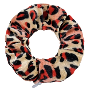 Detail view of tie-dye leopard print velvet scrunchie with hidden grey zipper pocket