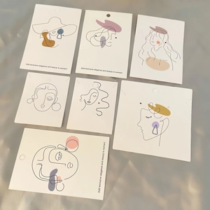 Minimalist line art jewelry display cards for earrings and necklaces on soft grey fabric