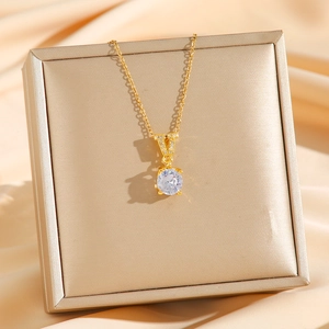 Golden titanium steel necklace featuring a V-shaped pendant with round cubic zirconia