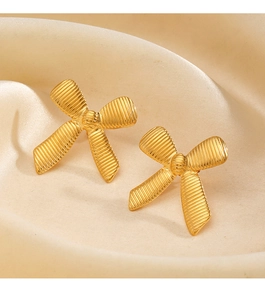 Macro shot of 18K gold plated bow earrings featuring exquisite horizontal textures