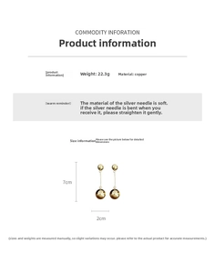 Detail of long gold ball drop earrings with silver pins and weight specifications