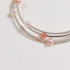 Three-layer freshwater pearl wrap bracelet with white, pink, and champagne pearls
