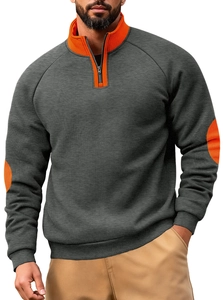 Detail of color-block sweatshirt with orange collar and elbow patches on dark grey fabric