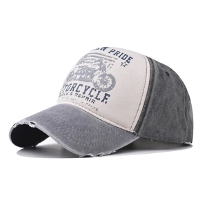 Detail of distressed cotton baseball cap showing vintage motorcycle print and frayed brim