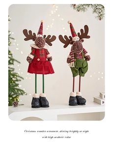 Detail of plush Christmas elk figurines with wood legs and festive red and green outfits