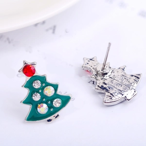 Macro detail of Christmas tree stud earrings with green enamel and crystal inlay