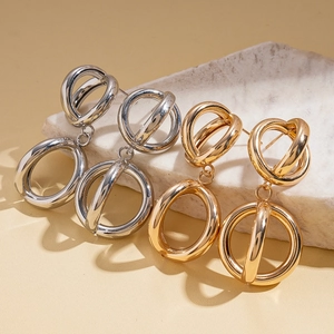 Polished geometric hollow earrings in gold and silver finish with interlocking design