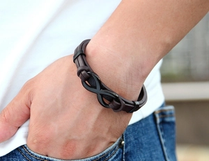 Close-up of men's dark brown braided leather bracelet with black metal infinity clasp