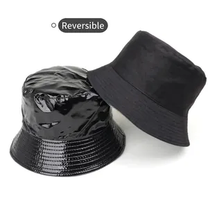 Reversible black bucket hat in glossy faux leather and matte cotton fabric