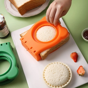 Orange and green round sandwich cutter molds pressing toast for DIY crustless pockets