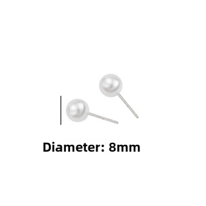 Close-up of elegant 8mm round white pearl earrings with silver needles on plain background