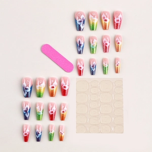 Glitter gradient press-on nails with white flower patterns, including file and glue