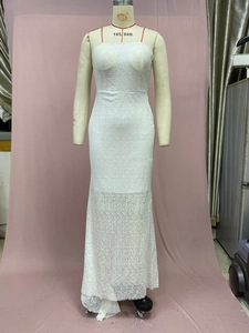 Detailed view of white floral lace texture and mermaid hem on a V-neck evening gown