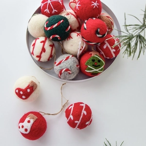 Handmade wool felt Christmas ornaments with star and stripe patterns in festive colors