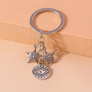 Detailed shot of vintage silver metal keychain with celestial sun and eye charms