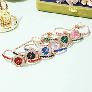 Luxury women's gold quartz bracelet watches with colorful gemstone accents and metal bands