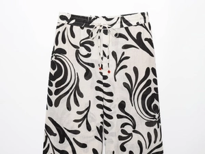 Detail of floral print trousers with adjustable drawstring and red bead accents
