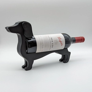 Macro shot of the black dachshund wine bottle holder highlighting its sleek textured finish