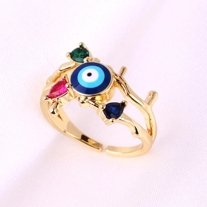 Detail of adjustable golden ring featuring blue evil eye and colorful zircon accents
