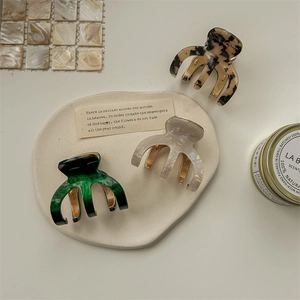 Three acetate hair claws in tortoise shell and marble colors for high ponytail styling