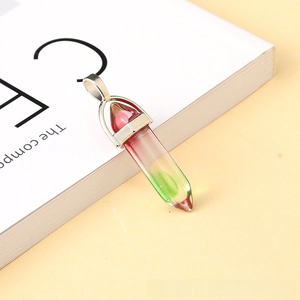 Macro detail of hexagonal crystal pendant with red and green gradient glass and silver clasp